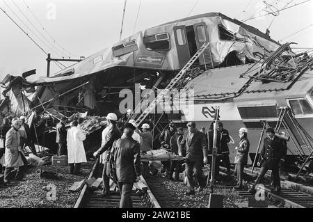 Train accident near Rotterdam; head-on collision between the North-West Express and local train Hague-Rotterdam, which caused three deaths and thirty-two people were injured  the havoc Overview Date: December 27, 1982 Location: Rotterdam, South Holland Keywords: aid, victims of railway accidents wrecks Person Name: North West Express Stock Photo