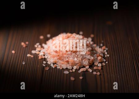 heap of Himalayan salt on a wooden surface Stock Photo