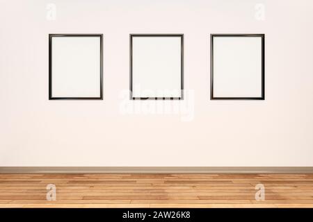 Three blank picture frames in a row on a cream wall in a large room Stock Photo