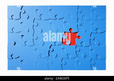 Blue jigsaw puzzle with one piece missing Stock Photo