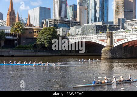 Yarra river in Melbourne city centre, teenage girls rowing on the river in front of city centre office buildings,Melbourne,Victoria,Australia Stock Photo