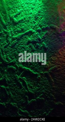Painted wall background in green neon light Stock Photo