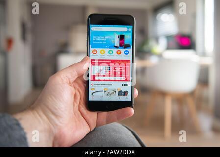 Amsterdam, The Netherlands, 02/06/2020, Man holding his smartphone, AliExpress start screen on smartphone, mobile screen. Chinese online shopping plat Stock Photo