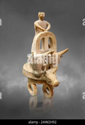 Minoan cult model of a 3 wheeled chariot drawn by a bull with a ...