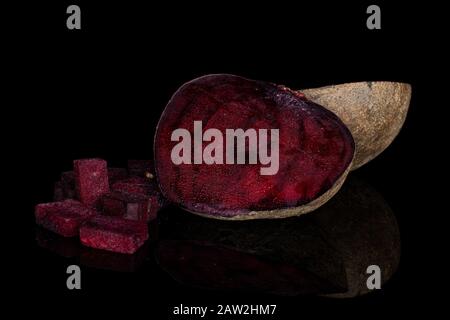 Group of two halves four pieces of raw sweet beetroot isolated on black glass Stock Photo
