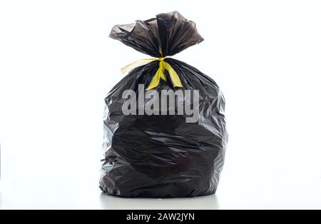 Trash, garbage bag black color full with litter and tied isolated against white background Stock Photo