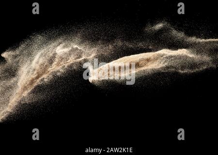 Dry river sand explosion isolated on black background. Abstract sand cloud.Brown colored sand splash. Stock Photo