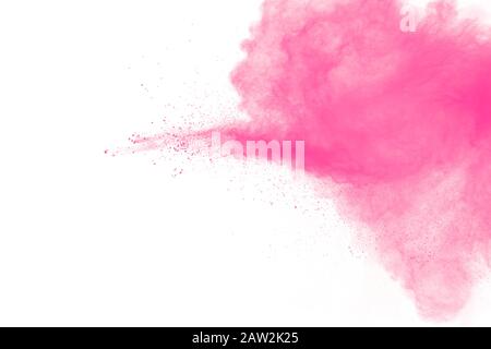 Abstract pink dust particles explosion on white background.Freeze motion of pink powder splash. Stock Photo
