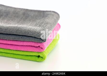 Cleaning towels microfiber cloth isolated against white background, Folded cleaning textile napkins colorful stack. Domestic household cleaning Stock Photo