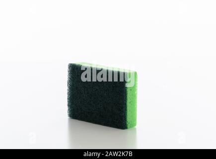 Cleaning kitchen sponge isolated against white background. Green color sponge for dish washing, household supplies Stock Photo