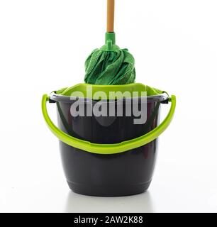 Cleaning mop on a bucket green black color isolated against white background, Domestic household cleaning Stock Photo