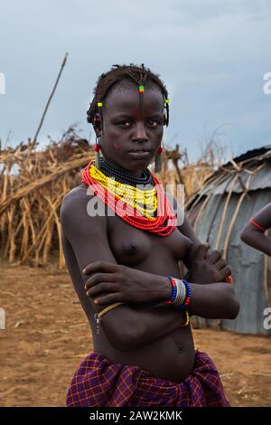 Omorate, Ethiopia - Nov 2018: Young woman of Dassanech tribe posing, wearing tradition colorful necklaces. Omo valley Stock Photo