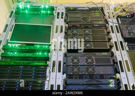 Powerful storage servers work in the server room racks. Hosting services in a modern data center. Computer equipment is located on the technical platf Stock Photo