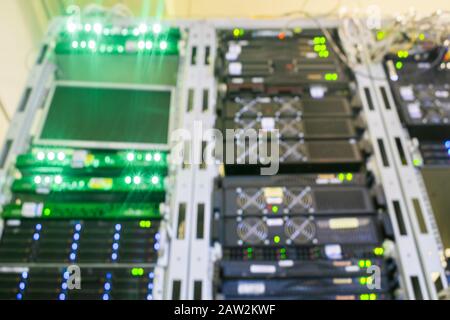 There are many racks with servers in the server room of the data center.Blurred background. Stock Photo