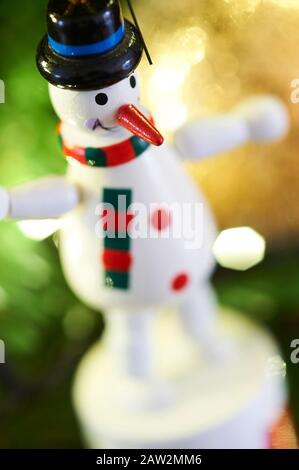 Wooden toy snowman tree decoration hanging on a Christmas tree Stock Photo