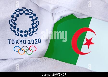 TOKYO, JAPAN, FEBRUARY. 4, 2020: Algeria National flag, official logo of summer olympic games in Tokyo 2020. White background Stock Photo