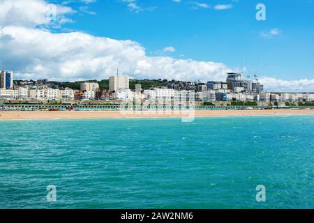 BRIGHTON, EAST SUSSEX, UK - JUNE 21 : View of Brighton town seafront, houses and beach from the pier in East Sussex on June 21, 2019 Stock Photo