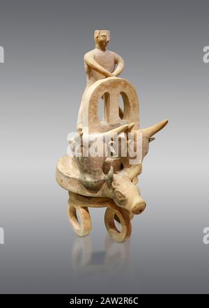 Minoan cult model of a 3 wheeled chariot drawn by a bull with a ...