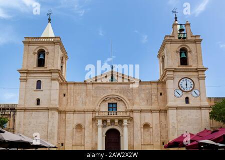 The facade of a Roman Catholic co-cathedral on the background of a pure blue sky in Valletta. Stock Photo