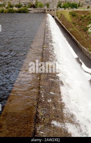 Overflowing dam at the Elan Valley after heavy rainfall. Stock Photo