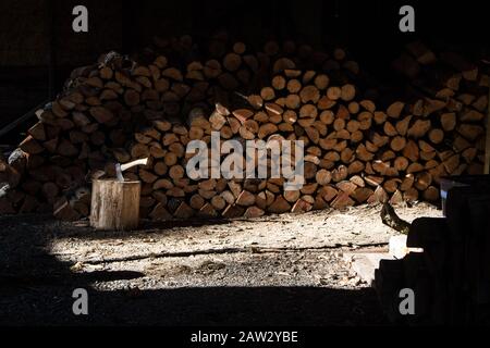 Wood chopping splitting with really dramatic light Stock Photo