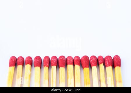 Line of some red wooden match sticks isolated on a white background with writing space Stock Photo