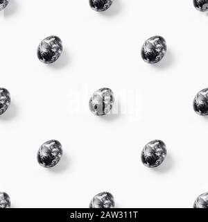 Creative seamless pattern made of easter black eggs on white background. Minimal monochrome food concept.Photography collage Stock Photo