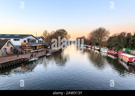 The River Lea, looking upriver from Spring Hill bridge, the Lea Rowing Club on the left, on a Sunday evening in winter, Upper Clapton, London, UK Stock Photo