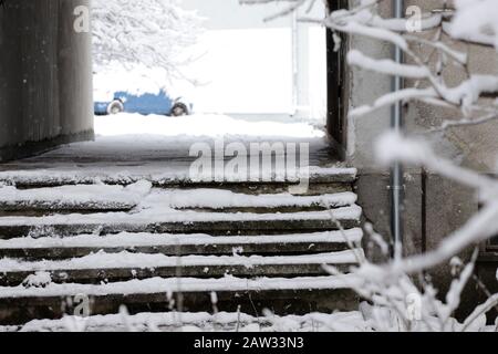 Dangerous uncleaned stairs in front the building, slippery stairs. Icy sidewalk. Stock Photo