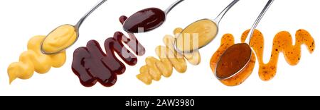 Set of various sauces in spoons isolated on white background Stock Photo