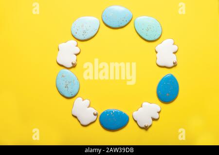 Easter cookies on a yellow background. Easter bunnies. Top view. Place for text. Easter eggs. Stock Photo