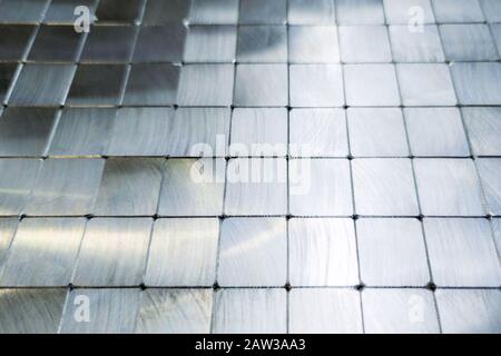 shiny steel machined blocks pavement surface background - close-up with selective focus and blur. Stock Photo
