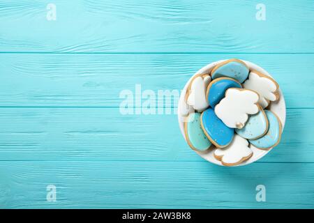 Easter cookies in a plate on a blue background. Easter eggs. Easter bunnies. Place for text. View from above Stock Photo