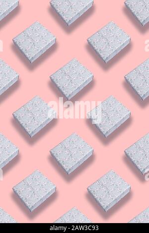 Seamless diagonal pattern of grey gift boxes with shadows on trendy pink pastel background. Valentine's day, mother's day, Women's day or Birthday. To Stock Photo