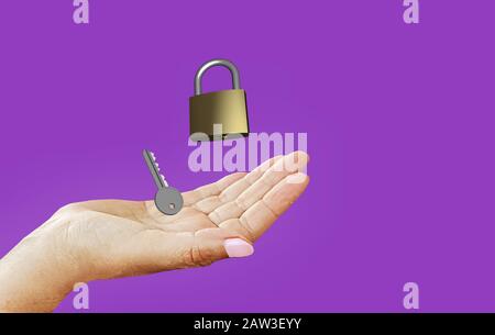 image symbolizing data protection and privacy: lock and key in your hand, on purple-violet background Stock Photo