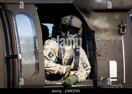 GRAVE, NETHERLANDS - SEP 17: Crew chief in a US Army UH-60 Black Hawk helicopter during the Operation Market Garden Memorial. Stock Photo