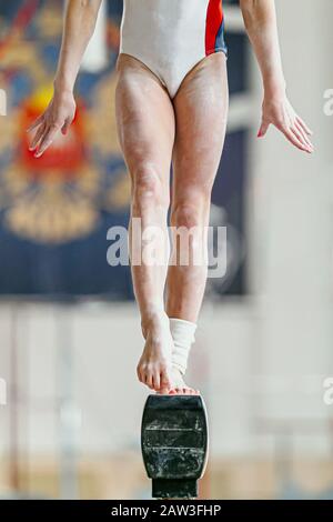 feet girl gymnast on balance beam in gymnastics Stock Photo