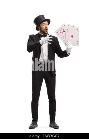 Full length portrait of a magician performing a magic trick with playing cards isolated on white background Stock Photo