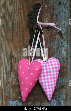 Two hearts on old wooden background Stock Photo