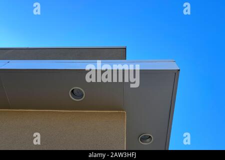 a blue sky with overhang building roof line Stock Photo