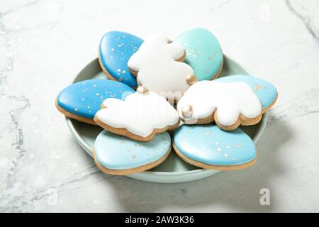 Easter cookies in a plate on a concrete background. Glass of milk. Easter eggs. Easter bunnies. Place for text. Stock Photo