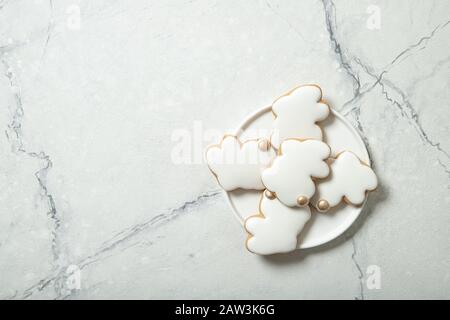 Easter cookies in a plate on a concrete background. Easter bunnies. Place for text. Top view. Close-up. Stock Photo