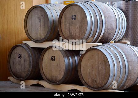 Barrels of Chianti wine maturing in winery in Tuscany, Italy Stock Photo