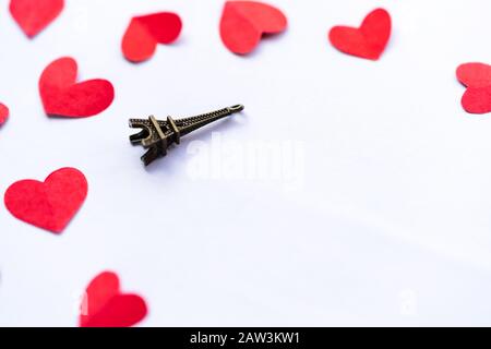 Valentines day still life photography with Eiffel tower & red hearts isolated on white background with copy space. Concept for gift, greetings card.