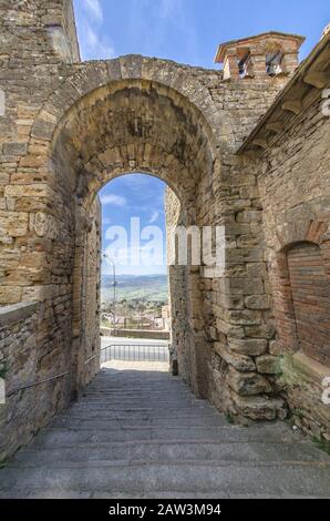 Ancient village with passage under archway in Tuscany Stock Photo