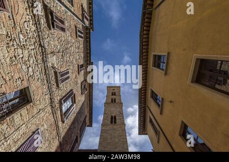 View of the bell tower of Volterra through the streets of the city Stock Photo