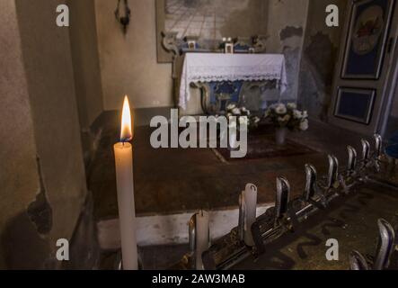 Burning candles inside a church Stock Photo