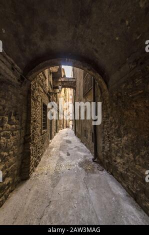 Ancient village with passage under archway in Tuscany Stock Photo