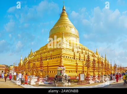 BAGAN, MYANMAR - FEBRUARY 25, 2018: Outstanding Shwezigon Pagoda with its giant golden stupa is the most popular landmark and most venerated place in Stock Photo