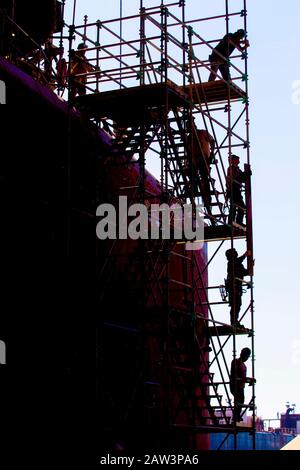 Shipyard maintenance workers working on scaffolding Stock Photo
